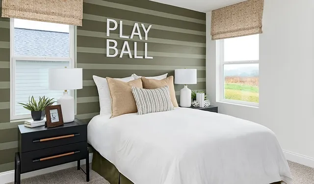 a bedroom with a bed and paintings on the wall