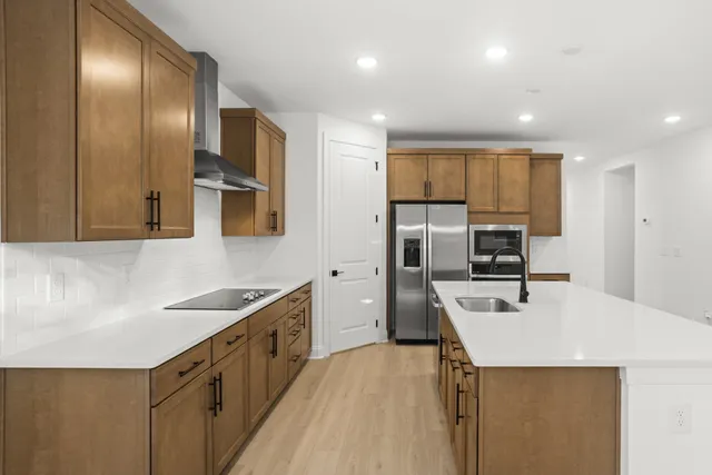 a kitchen with a sink cabinets and appliances