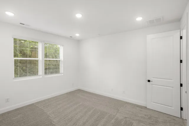 a view of kitchen with stainless steel appliances granite countertop a sink and cabinets