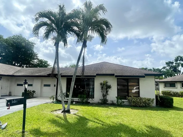 a view of a house with swimming pool and a yard