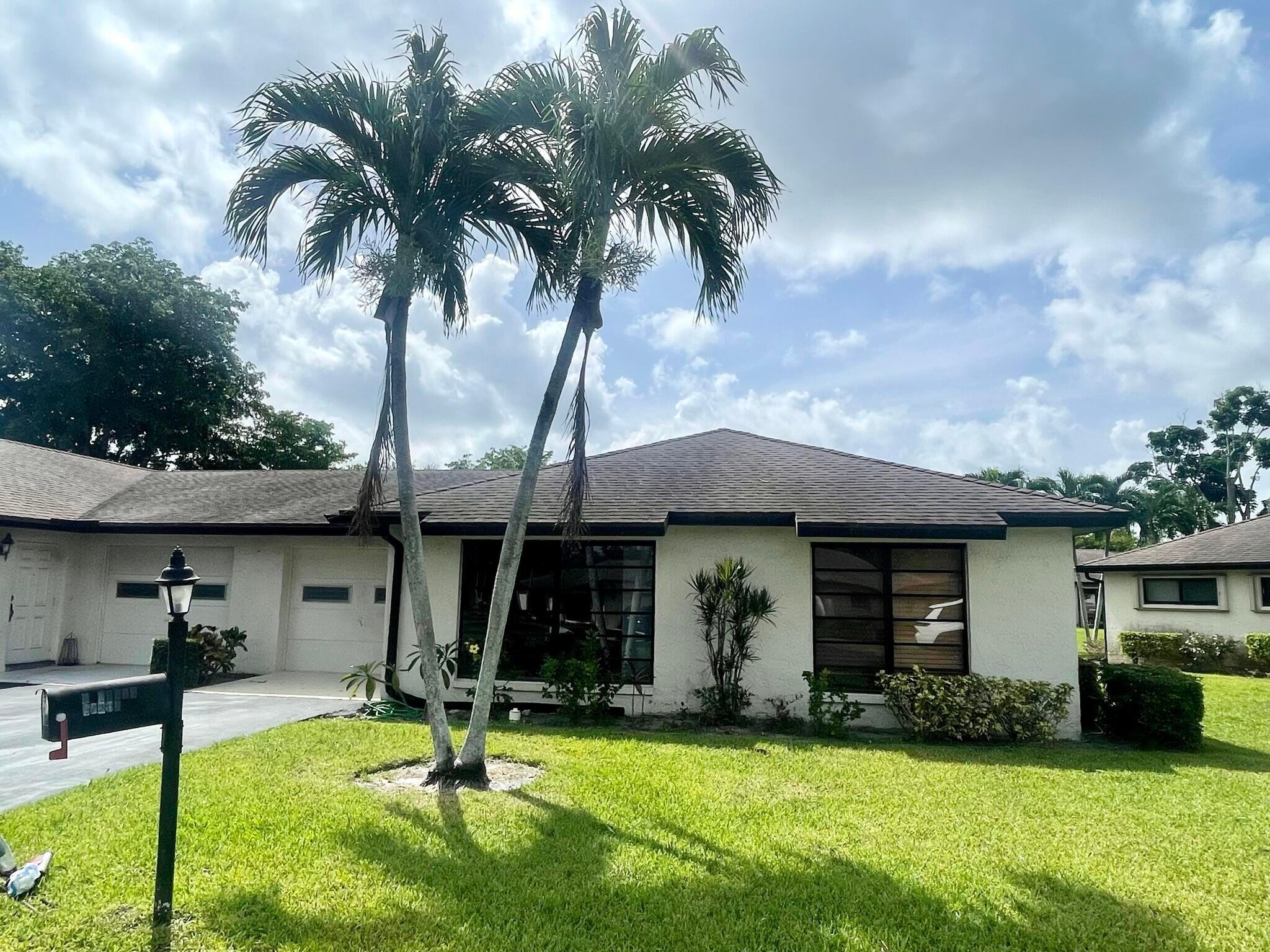 a view of a house with swimming pool and a yard