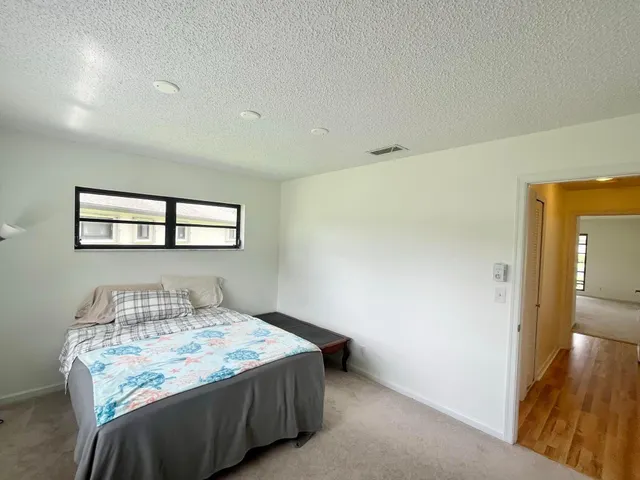 a bedroom with a bed and a table