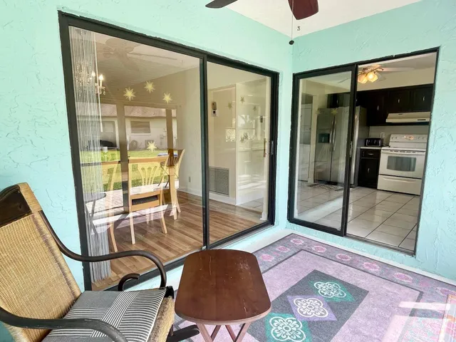 a view of a room with chairs and a potted plant