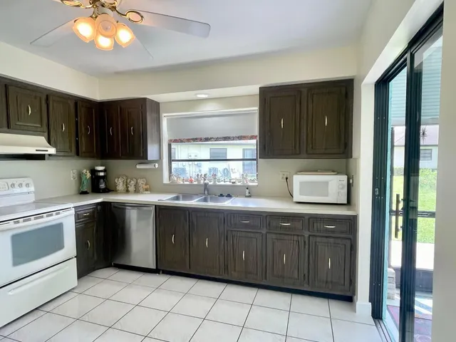 a kitchen with a sink cabinets and window