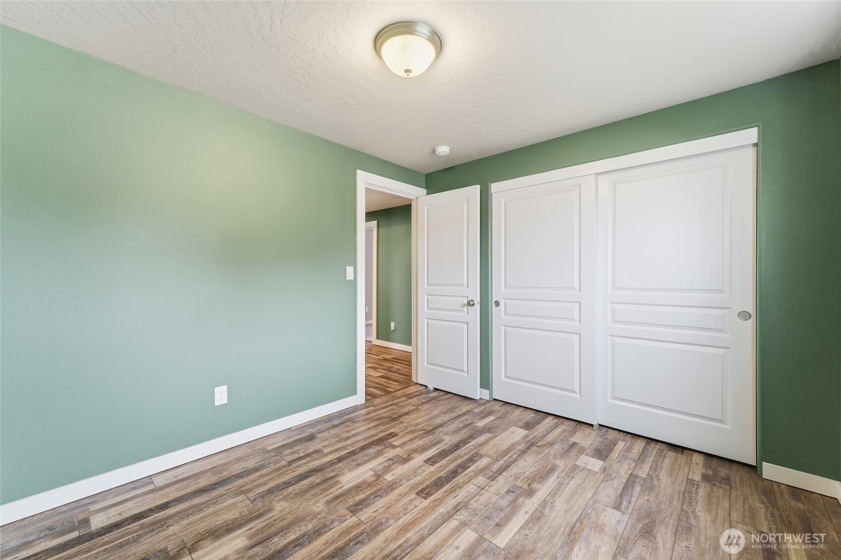 1339 Caprio Loop Walla Walla, WA 99362 - Photo 13 of 37 an empty room with wooden floor and closet