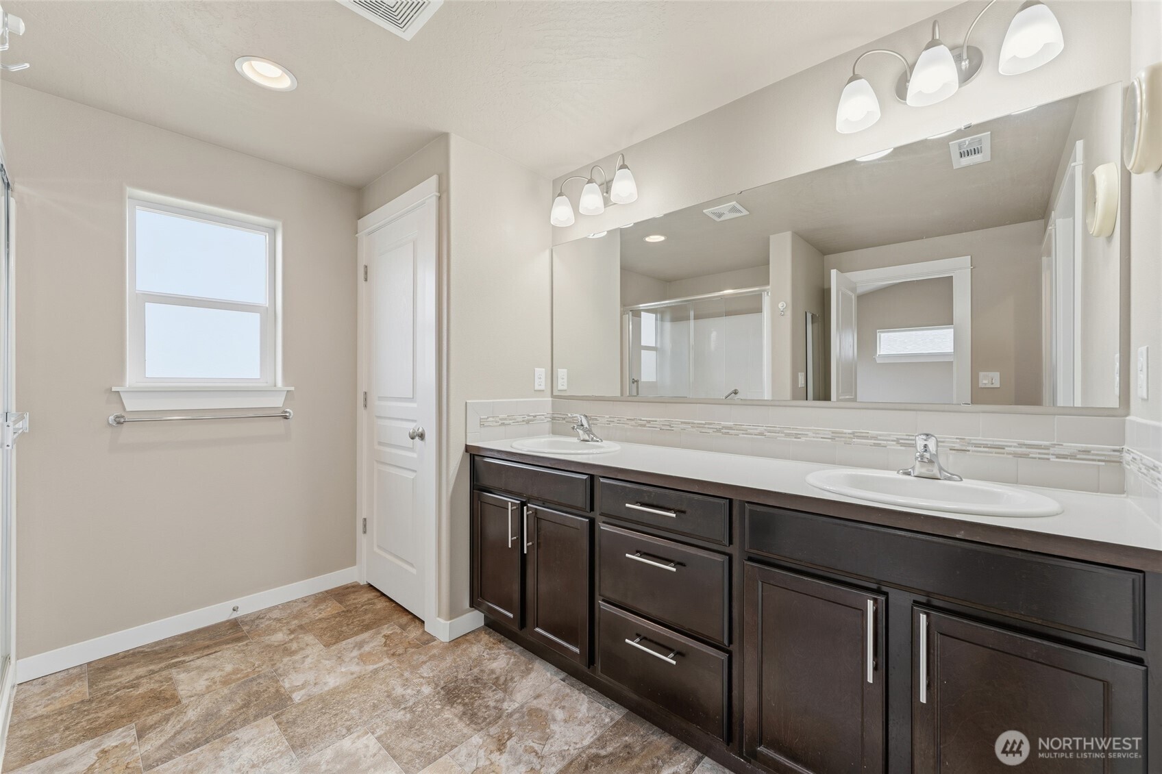 1339 Caprio Loop Walla Walla, WA 99362 - Photo 17 of 37 a spacious bathroom with a granite countertop sink a mirror and a