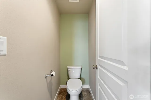 a white toilet sitting next to a shower