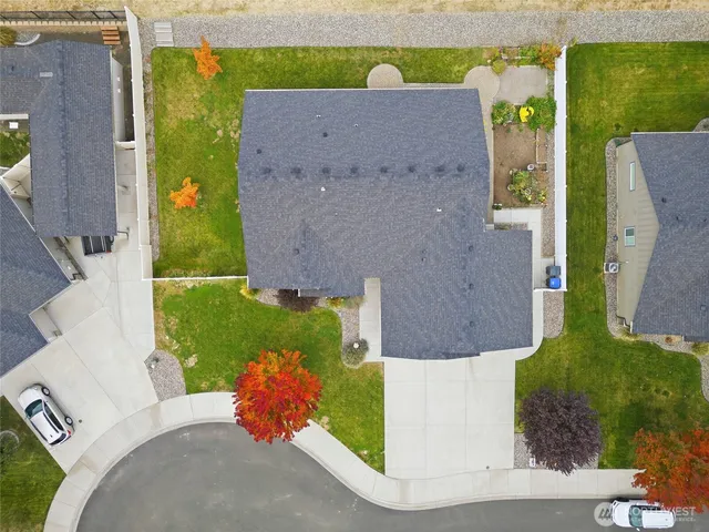an aerial view of a house with a yard