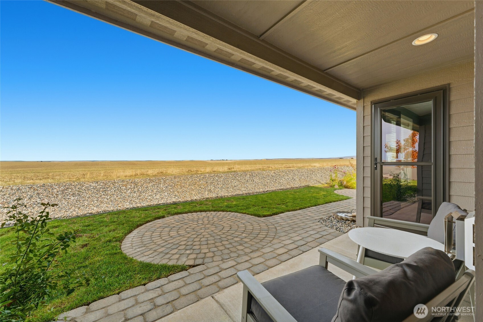 1339 Caprio Loop Walla Walla, WA 99362 - Photo 31 of 37 a view of a patio with lawn chairs next to a yard