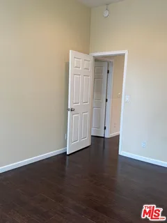 an entryway with a floor to ceiling window and wooden floor