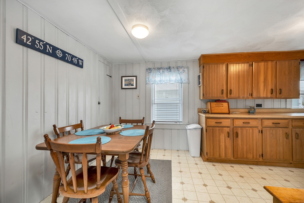 558 Winnacunnet Road Hampton, NH 03842 - Photo 23 of 40 a kitchen that has a table and chairs in it