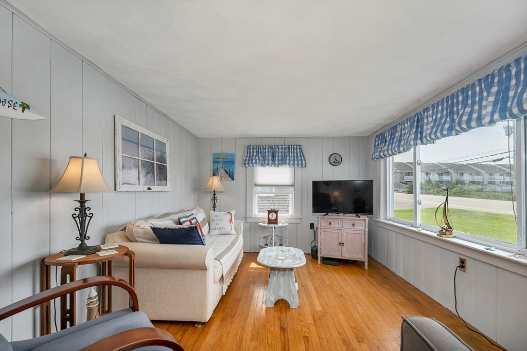 558 Winnacunnet Road Hampton, NH 03842 - Photo 26 of 40 a living room with furniture and a flat screen tv