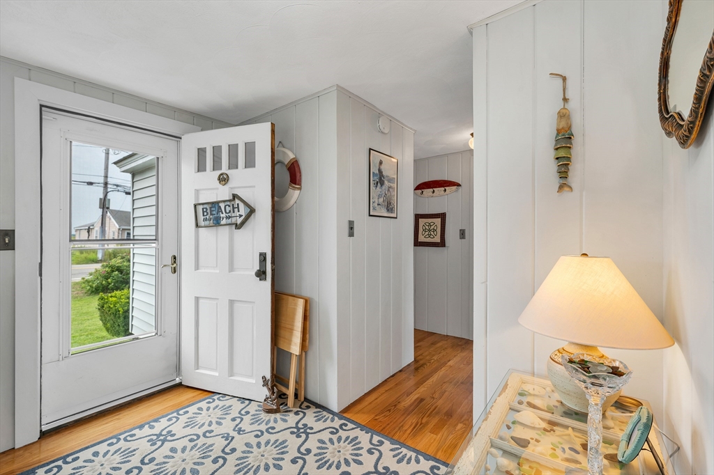 558 Winnacunnet Road Hampton, NH 03842 - Photo 29 of 40 a view of a bedroom with wooden floor and windows