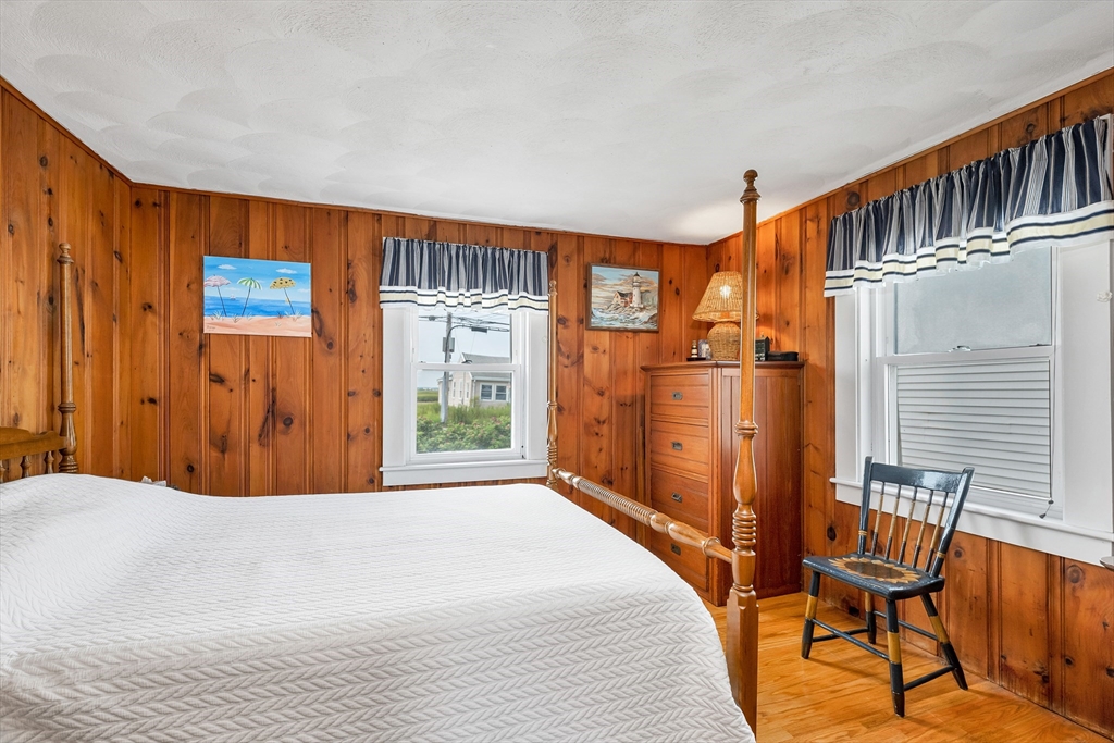 558 Winnacunnet Road Hampton, NH 03842 - Photo 30 of 40 a bed room with a bed and a chair