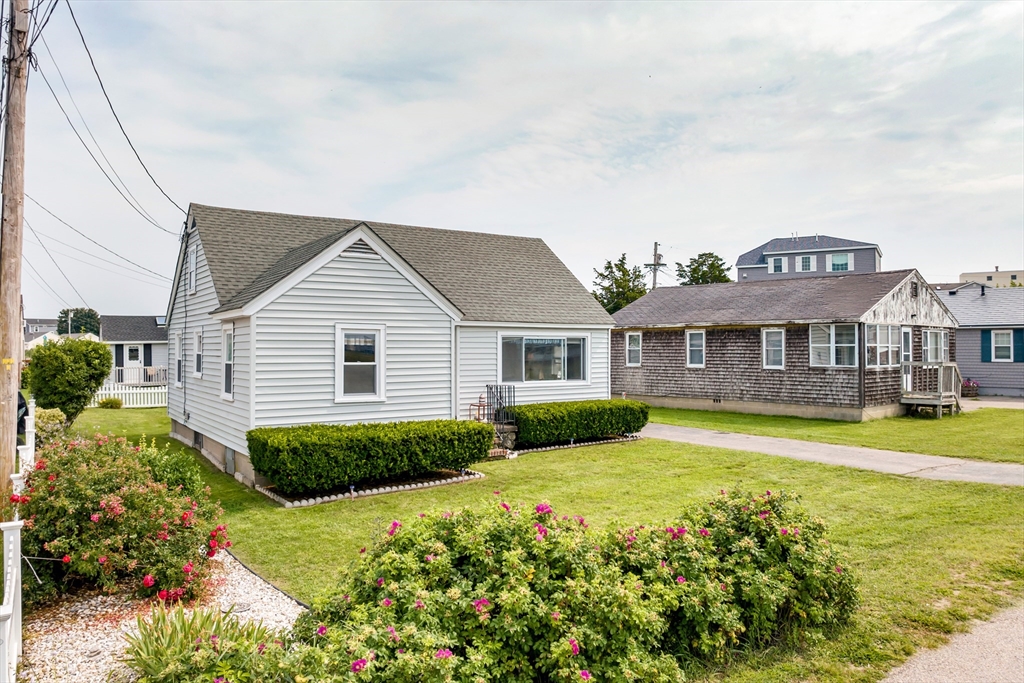 558 Winnacunnet Road Hampton, NH 03842 - Photo 3 of 40 a view of a house with a big yard and potted plants