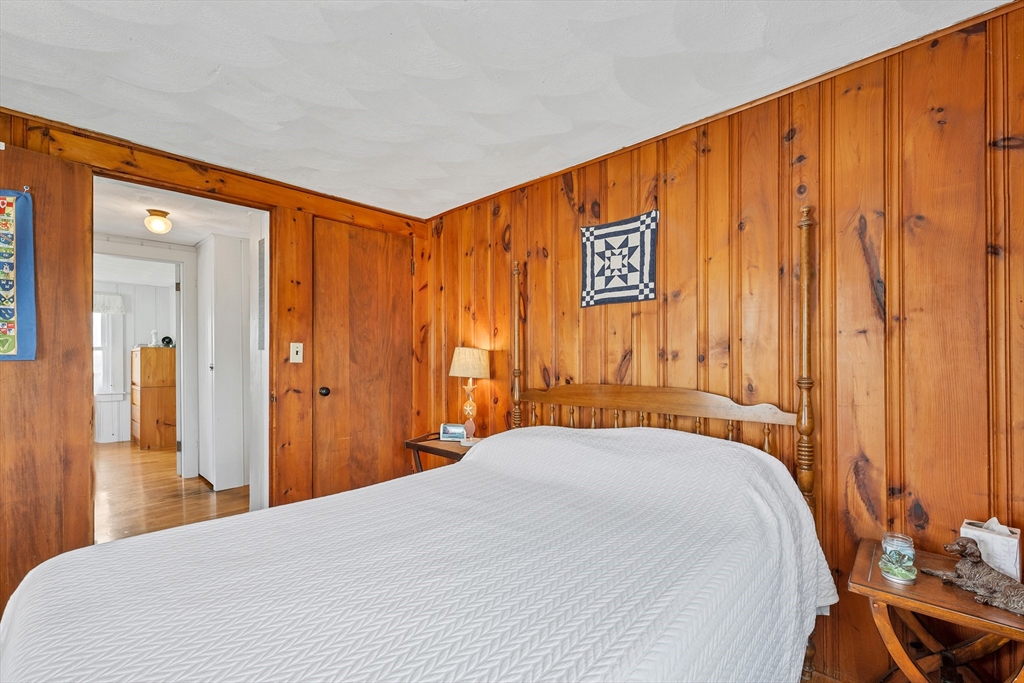 558 Winnacunnet Road Hampton, NH 03842 - Photo 31 of 40 a bedroom with a bed and a table