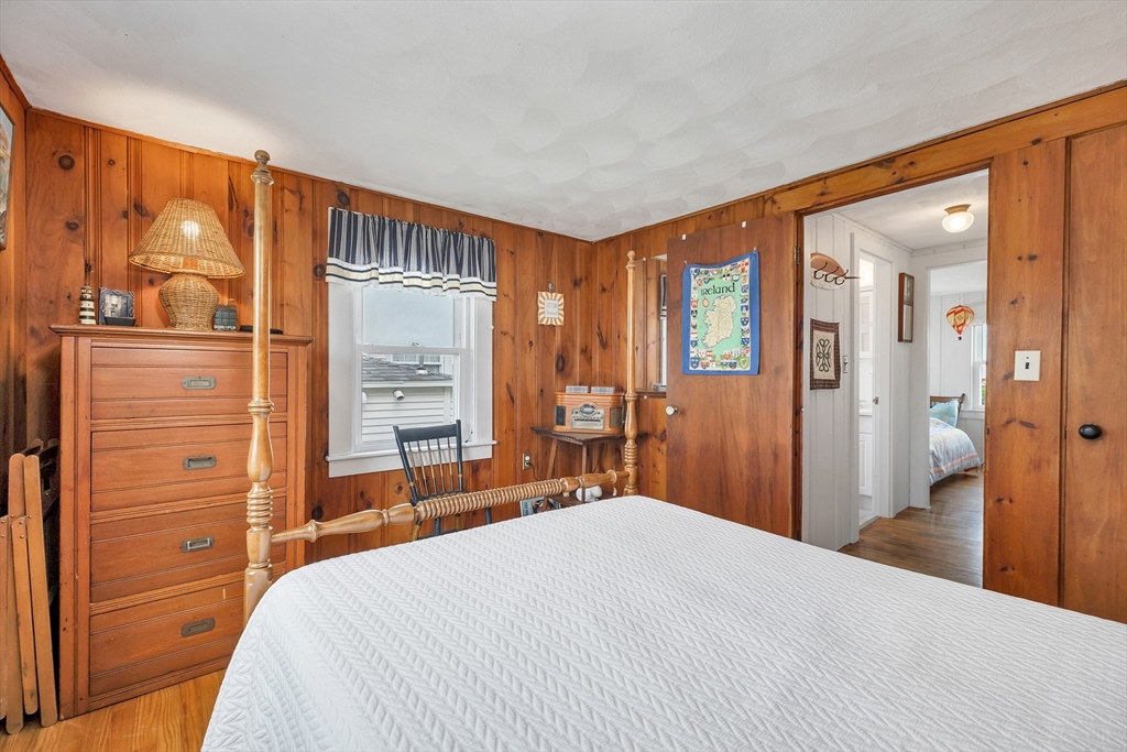 558 Winnacunnet Road Hampton, NH 03842 - Photo 32 of 40 a bedroom with a bed and a dresser