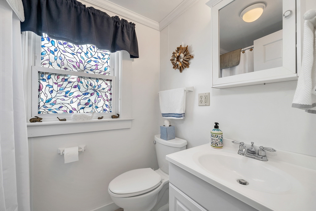 558 Winnacunnet Road Hampton, NH 03842 - Photo 34 of 40 a bathroom with a toilet sink and mirror