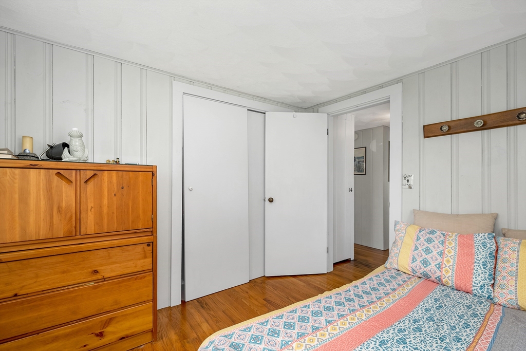 558 Winnacunnet Road Hampton, NH 03842 - Photo 37 of 40 a bedroom with a bed and a cabinet