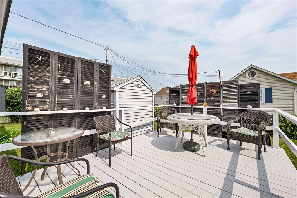 558 Winnacunnet Road Hampton, NH 03842 - Photo 38 of 40 a view of a roof deck with table and chairs