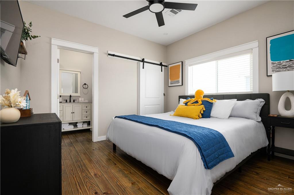 1053 Johnson Road Port Bolivar, TX 77617 - Photo 19 of 27 a bedroom with a bed and wooden floor