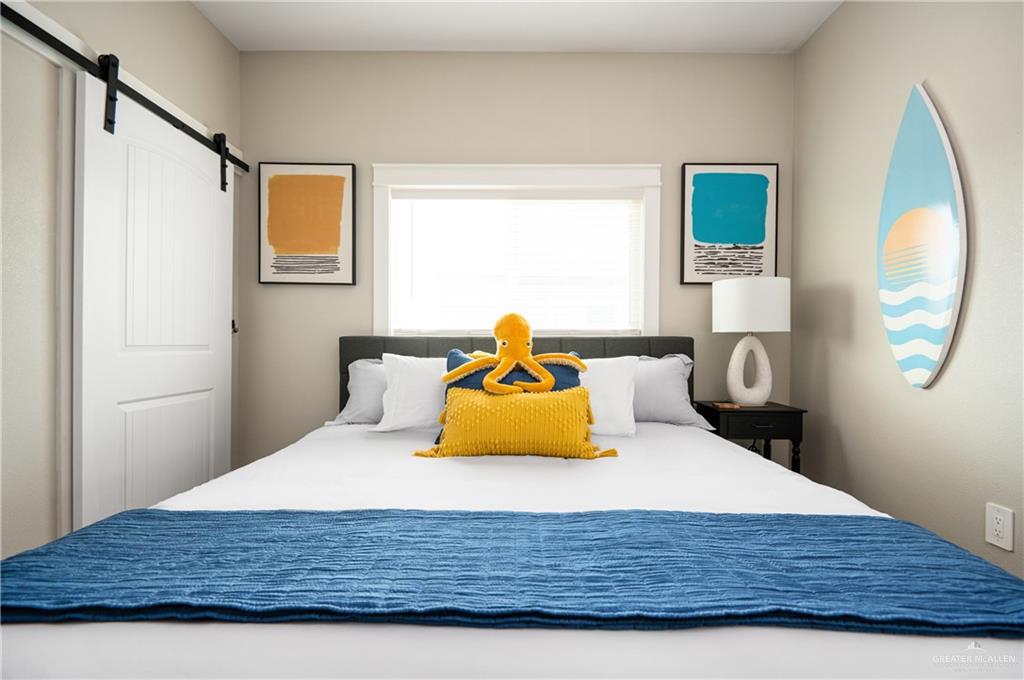 1053 Johnson Road Port Bolivar, TX 77617 - Photo 20 of 27 a bedroom with a bed and wooden floor