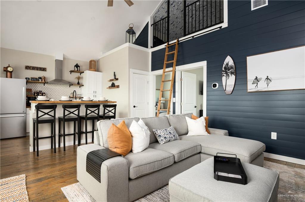 1053 Johnson Road Port Bolivar, TX 77617 - Photo 9 of 27 a living room with furniture a dining table and chairs with wooden floor