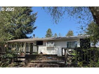 5590 South Shore Drive Florence, OR 97439 - Photo 8 of 11 a front view of a house with a garden