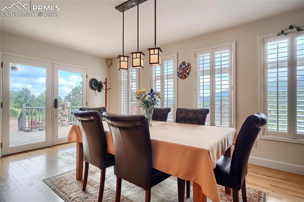 623 West Meadow Road Evergreen, CO 80439 - Photo 16 of 49 a view of a dining room with furniture window and wooden floor