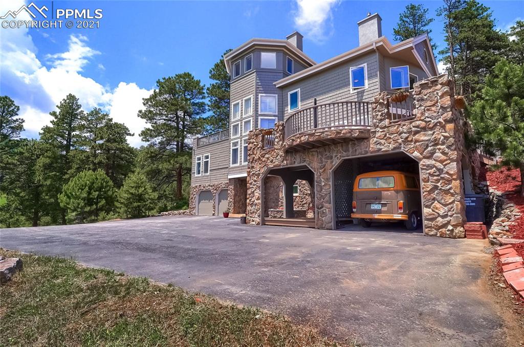 623 West Meadow Road Evergreen, CO 80439 - Photo 3 of 49 a front view of a house with yard and parking