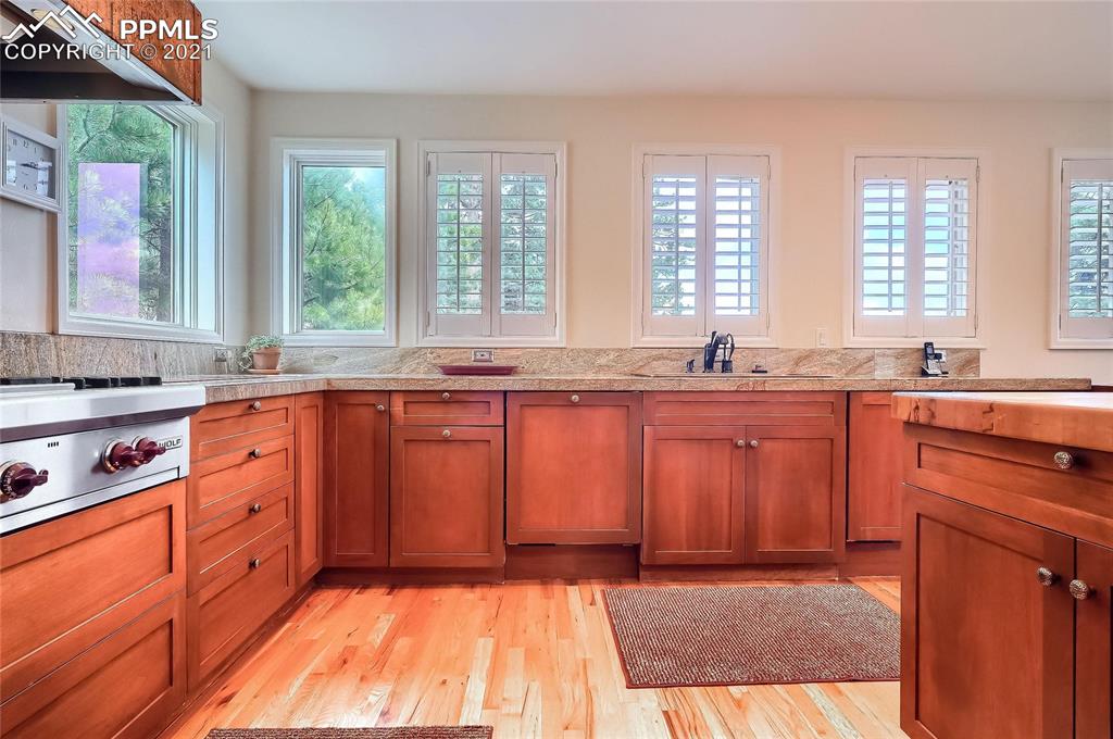 623 West Meadow Road Evergreen, CO 80439 - Photo 22 of 49 a large kitchen with granite countertop a stove a sink dishwasher and a microwave oven with granite countertops