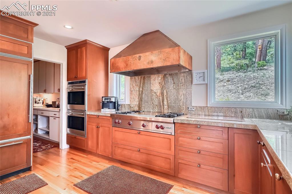 623 West Meadow Road Evergreen, CO 80439 - Photo 24 of 49 a kitchen with stainless steel appliances granite countertop a stove a sink and a microwave