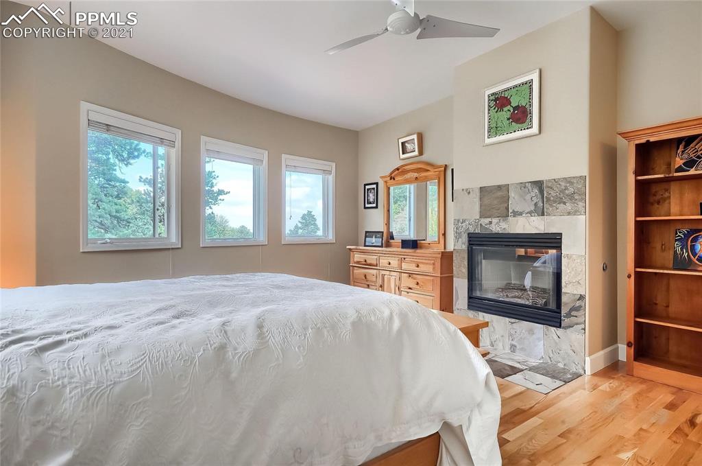 623 West Meadow Road Evergreen, CO 80439 - Photo 37 of 49 a spacious bedroom with a bed and a flat screen tv