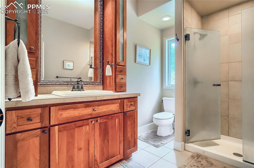 623 West Meadow Road Evergreen, CO 80439 - Photo 38 of 49 a bathroom with a double vanity sink toilet and shower