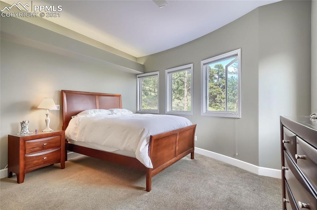 623 West Meadow Road Evergreen, CO 80439 - Photo 39 of 49 a bed sitting in a bedroom next to a window