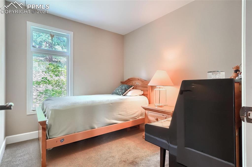623 West Meadow Road Evergreen, CO 80439 - Photo 42 of 49 a bed sitting in a bedroom next to a window