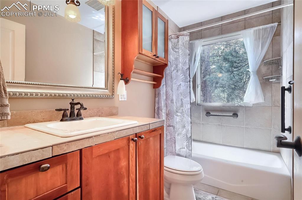 623 West Meadow Road Evergreen, CO 80439 - Photo 43 of 49 a bathroom with a sink a toilet and a mirror