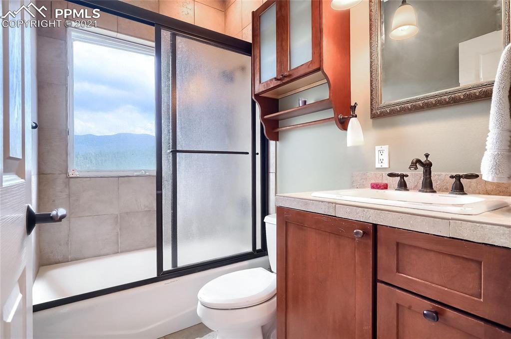 623 West Meadow Road Evergreen, CO 80439 - Photo 44 of 49 a bathroom with a sink a toilet and shower