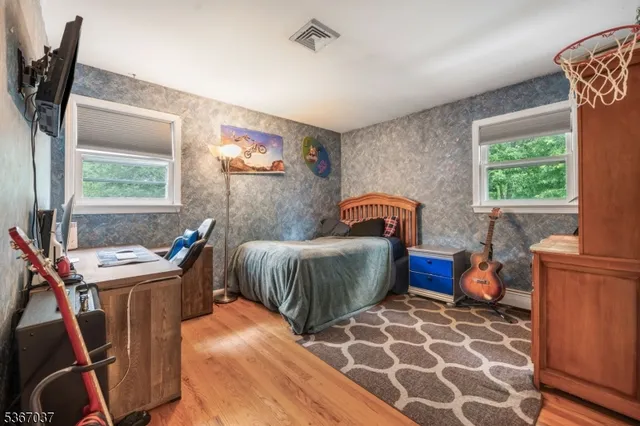 a bedroom with furniture and a window