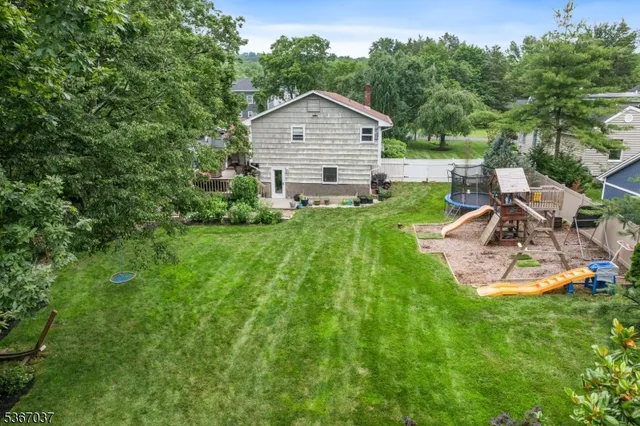 an aerial view of a house with swimming pool and garden