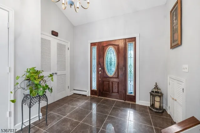 a living room with furniture a potted plant and a window
