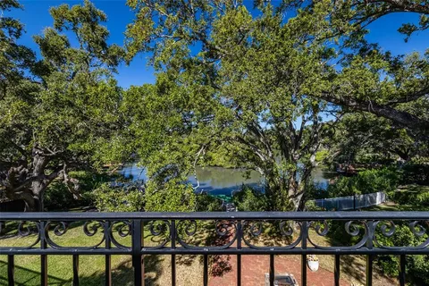 an aerial view of residential houses with outdoor space and trees