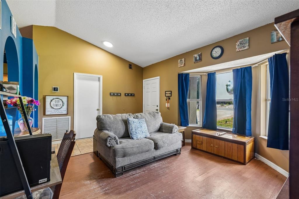 10303 Fordham Street Spring Hill, FL 34608 - Photo 2 of 25 a living room with furniture and a window
