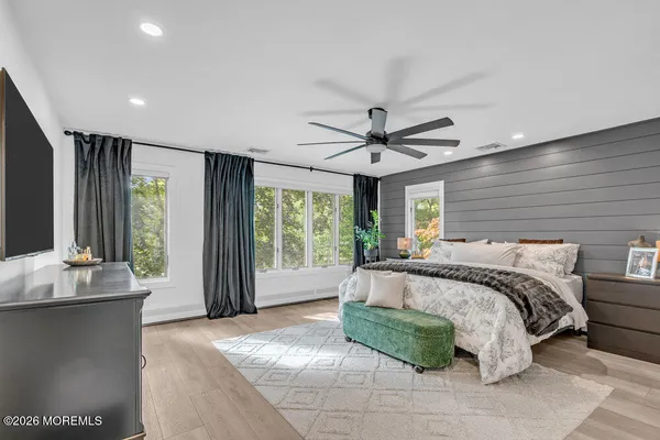 a spacious bedroom with a large bed and a large window