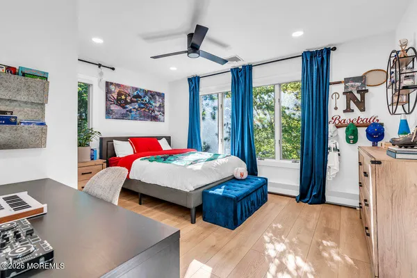a bedroom with a bed and a large window