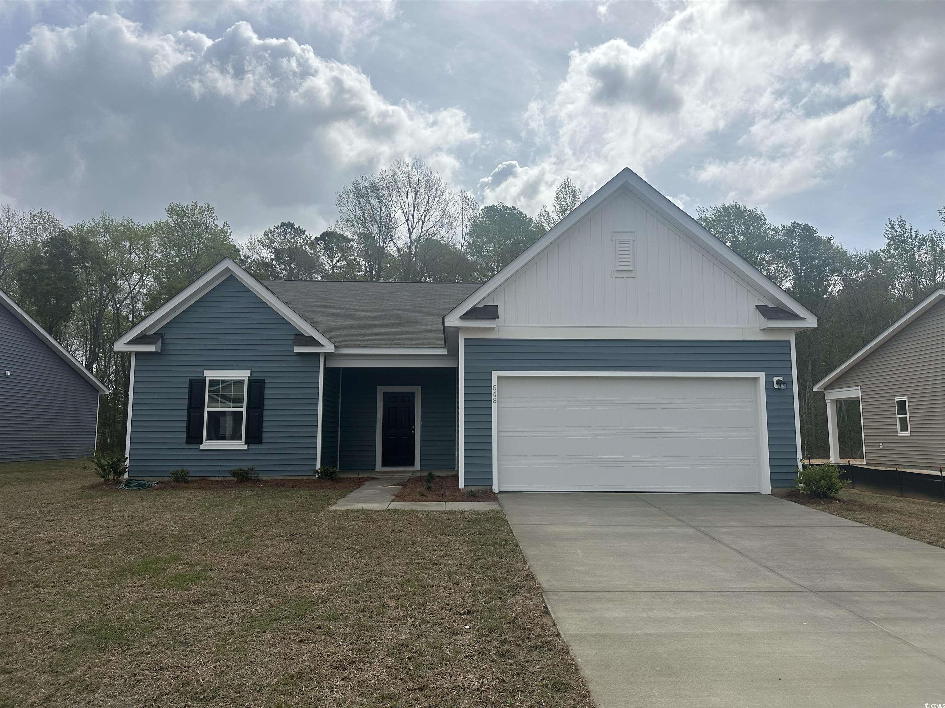 648 Castillo Drive Loris, SC 29569 - Photo 1 of 15 Ranch-style home with a garage, concrete driveway,
