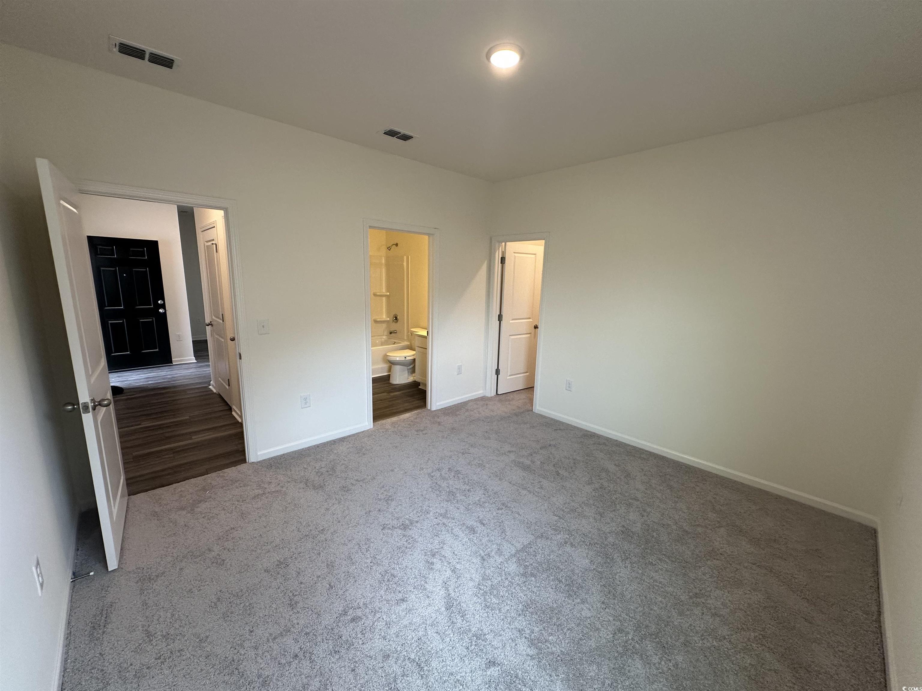 648 Castillo Drive Loris, SC 29569 - Photo 3 of 15 Unfurnished bedroom with ensuite bathroom, carpet,