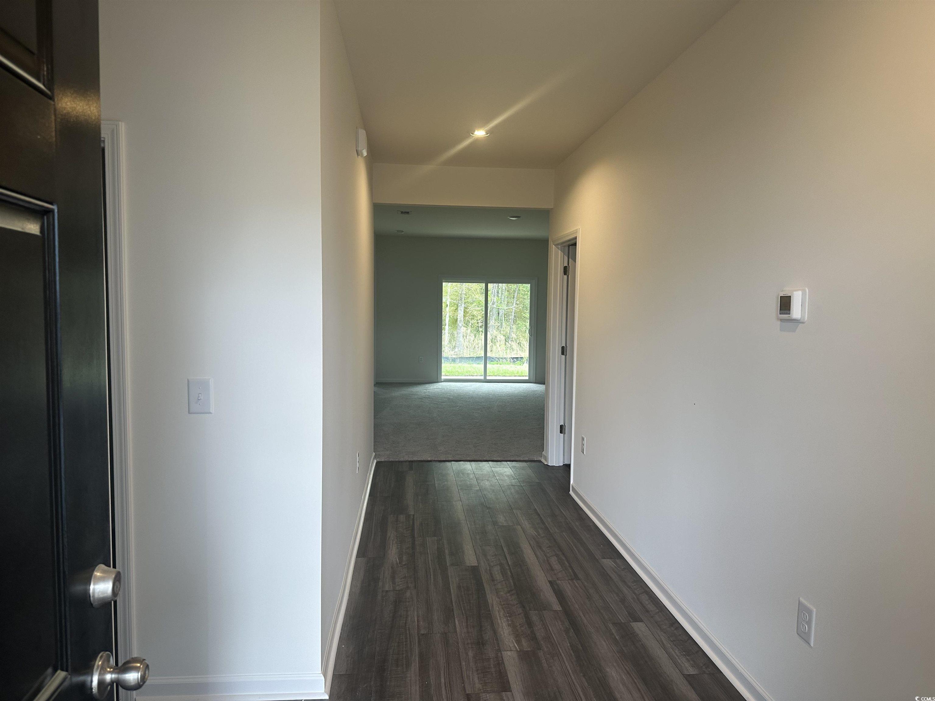 648 Castillo Drive Loris, SC 29569 - Photo 4 of 15 Corridor featuring dark wood-type flooring, basebo