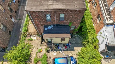 a aerial view of a house with a yard and potted plants