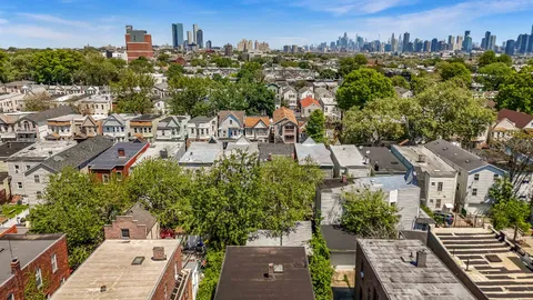 an aerial view of multiple houses with a yard